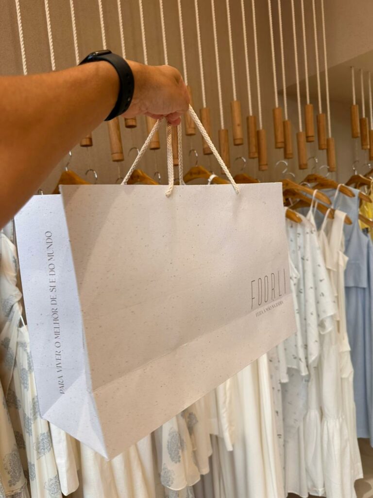 pessoa segurando sacolas de papel para lembrancinhas